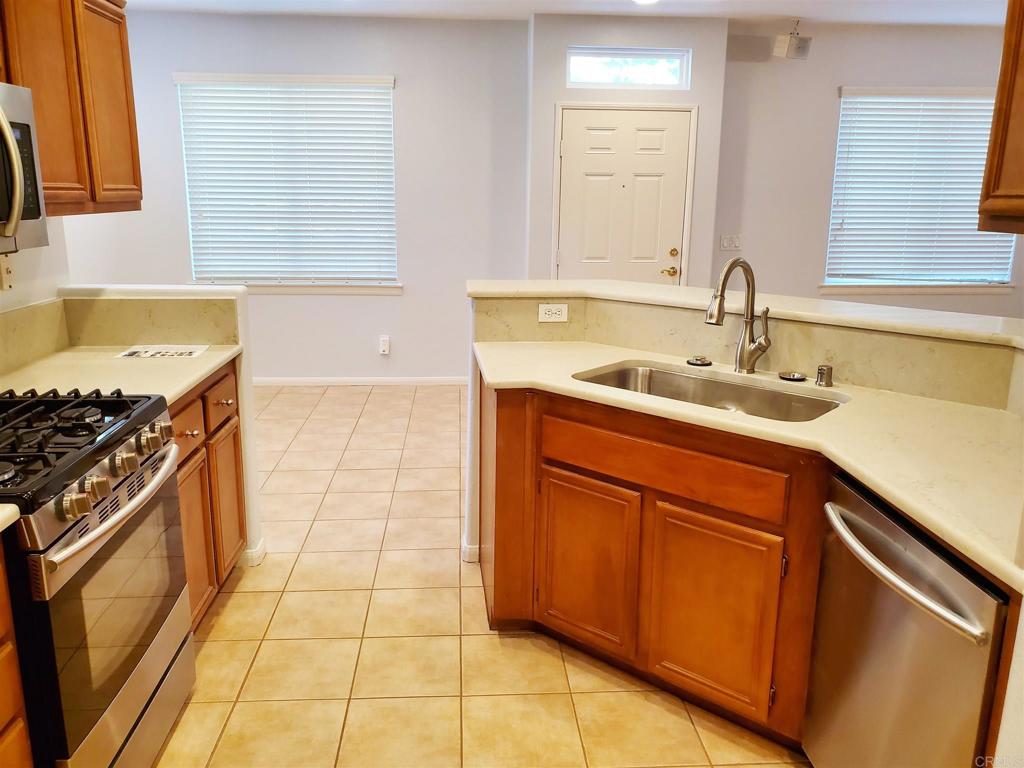6116 Citracado Circle Carlsbad, CA 92009 - Photo 10 of 32 a kitchen with a sink stove and cabinets