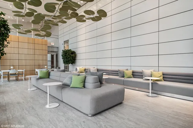 a living room with furniture and a potted plant