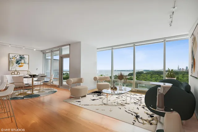 a living room with furniture and large windows