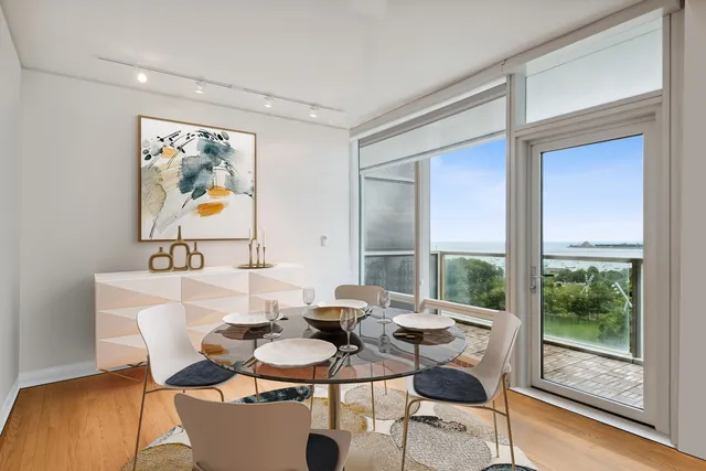 a view of a dining room with furniture large windows and wooden floor
