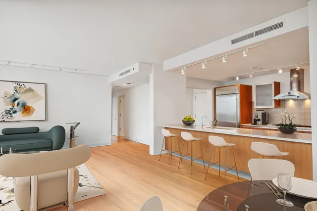a large white kitchen with a large window