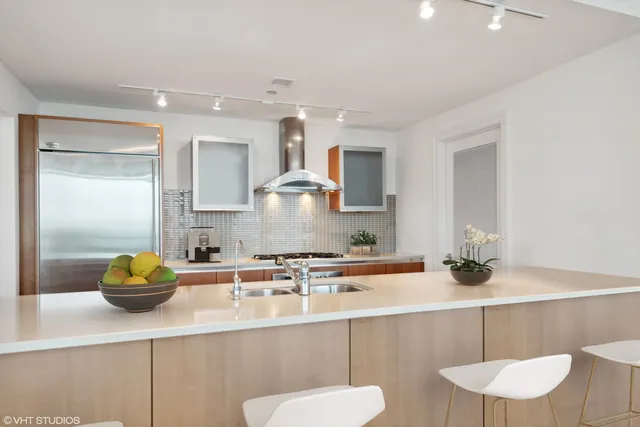 a kitchen with a sink a counter space and cabinets