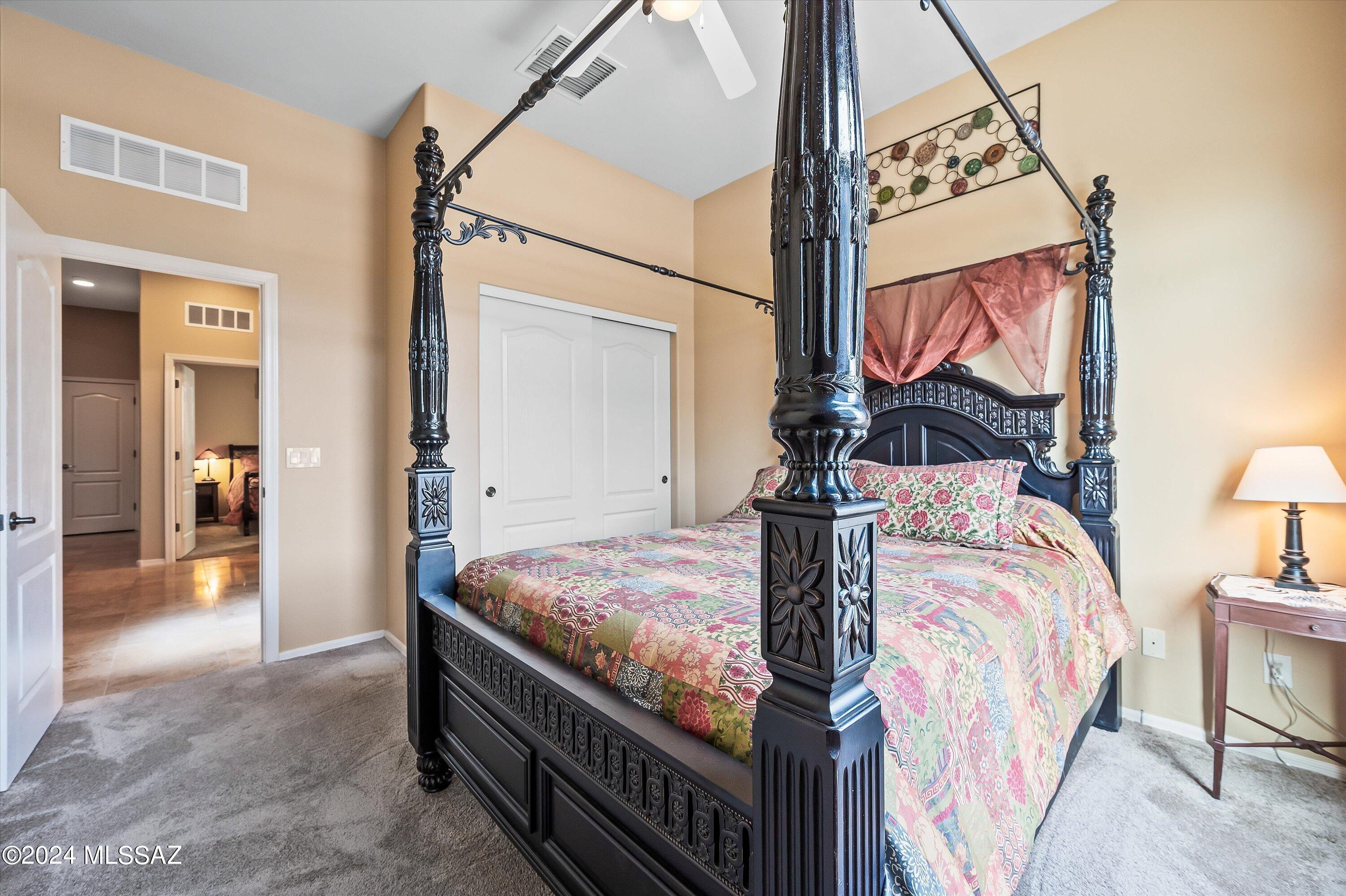 8579 North Shadow Wash Way Tucson, AZ 85743 - Photo 15 of 34 a bedroom with bed and a mirror