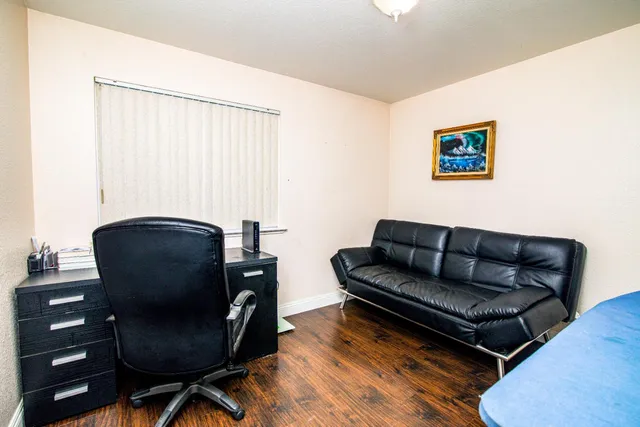 a living room with furniture rug and a window
