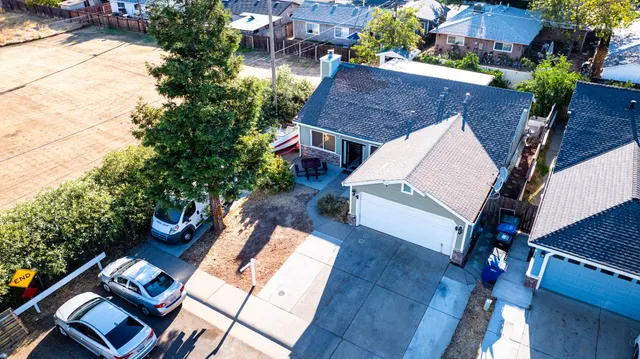 an aerial view of a house with balcony and garden