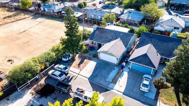 an aerial view of a house with wooden floor and outdoor space
