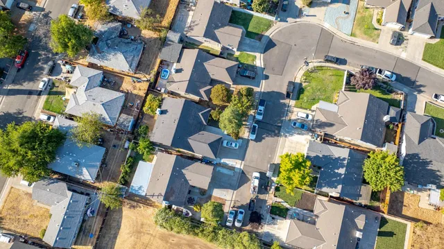 aerial view of multiple houses with yard