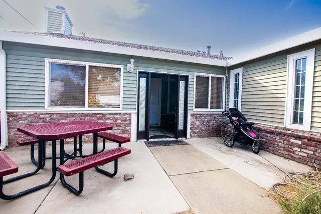 a view of a patio with a table and chairs and wooden floor