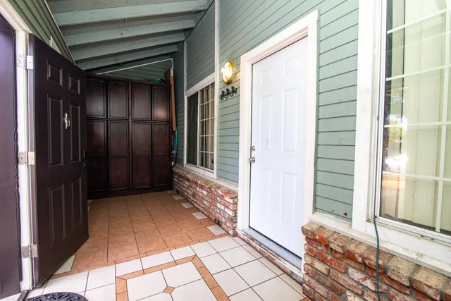 a view of a house with a door and wooden floor