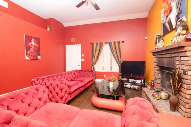 a living room with furniture and a floor to ceiling window
