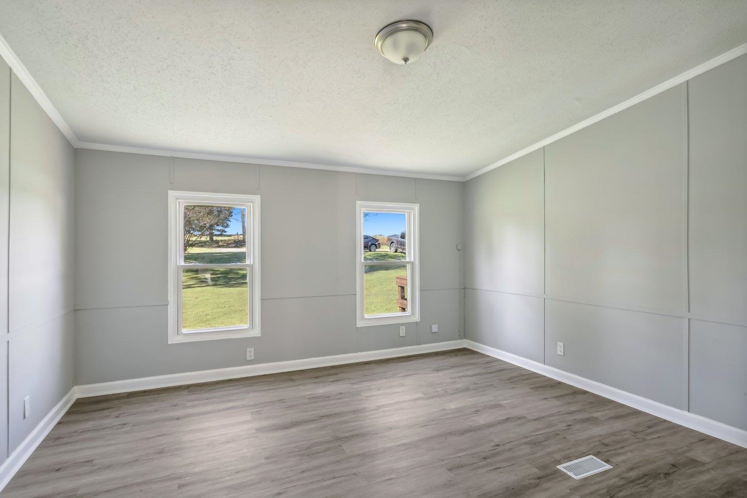 506 Charleston Gift Road Covington, TN 38019 - Photo 17 of 23 Empty room featuring crown molding, plenty of natural light,