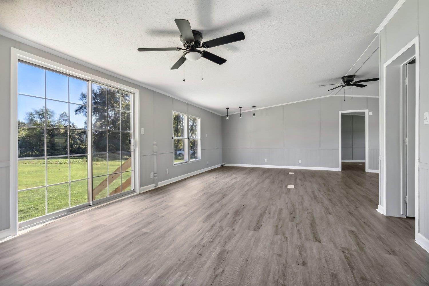 506 Charleston Gift Road Covington, TN 38019 - Photo 7 of 23 Unfurnished living room with a textured ceiling and ceiling fan