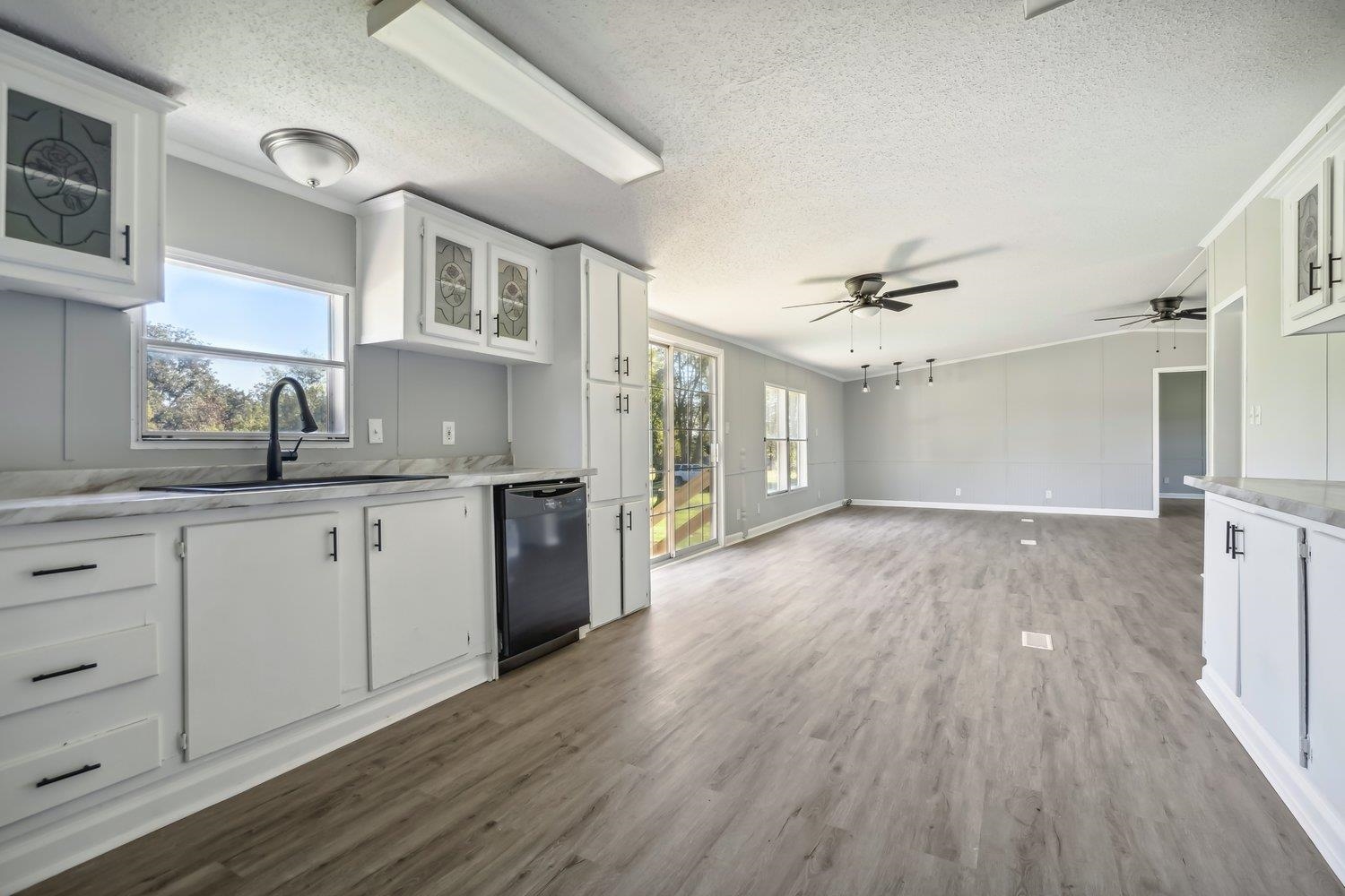 506 Charleston Gift Road Covington, TN 38019 - Photo 10 of 23 Kitchen featuring white cabinets, black dishwasher,