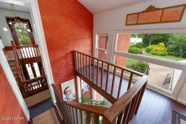 a view of an entryway with wooden floor