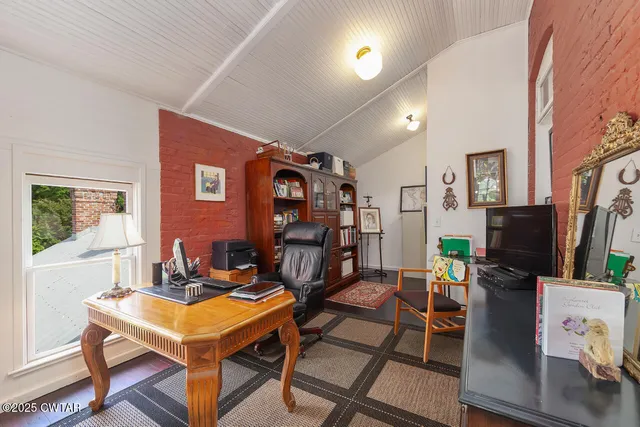 a room with furniture a flat screen tv and a table