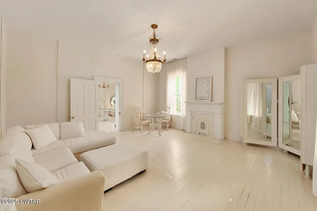 a living room with furniture a chandelier and a chandelier