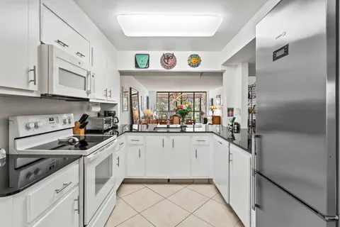 a kitchen with stainless steel appliances a sink and cabinets
