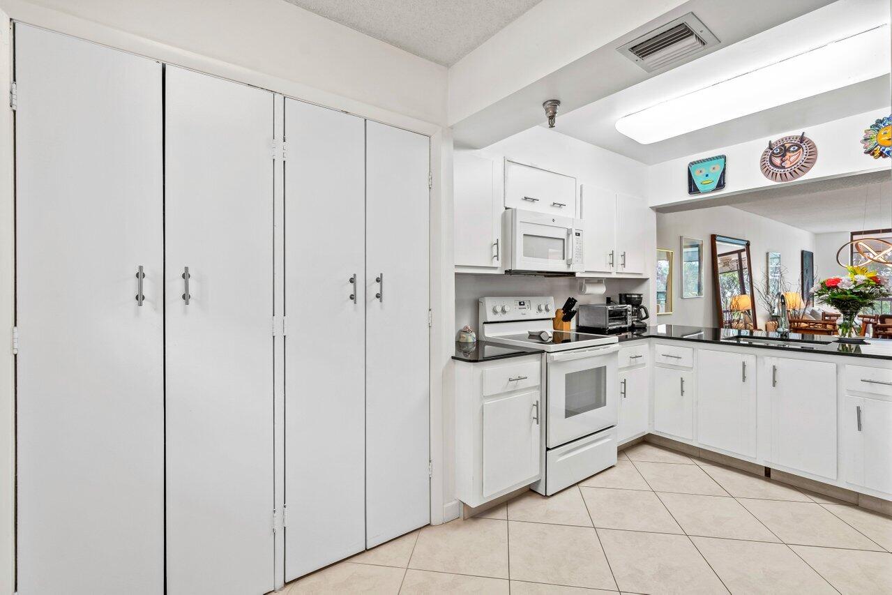 6320 Boca Del Mar Drive, Unit 302 Boca Raton, FL 33433 - Photo 14 of 35 a kitchen with cabinets and appliances