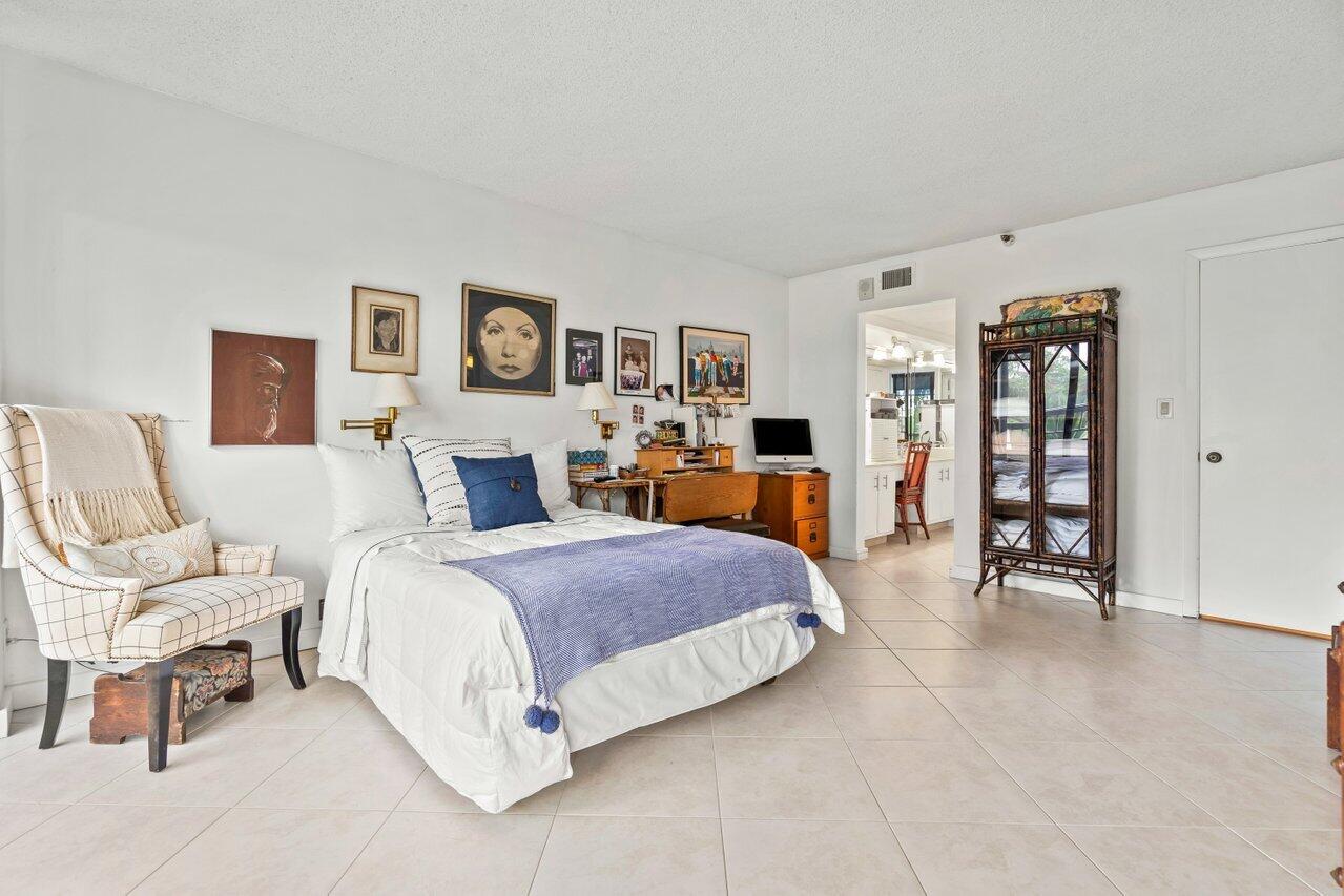 6320 Boca Del Mar Drive, Unit 302 Boca Raton, FL 33433 - Photo 18 of 35 a spacious bedroom with a bed a table and chair