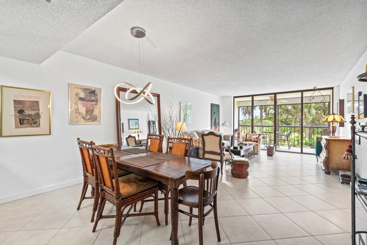 6320 Boca Del Mar Drive, Unit 302 Boca Raton, FL 33433 - Photo 2 of 35 a view of a dining room with furniture large windows and wooden floor