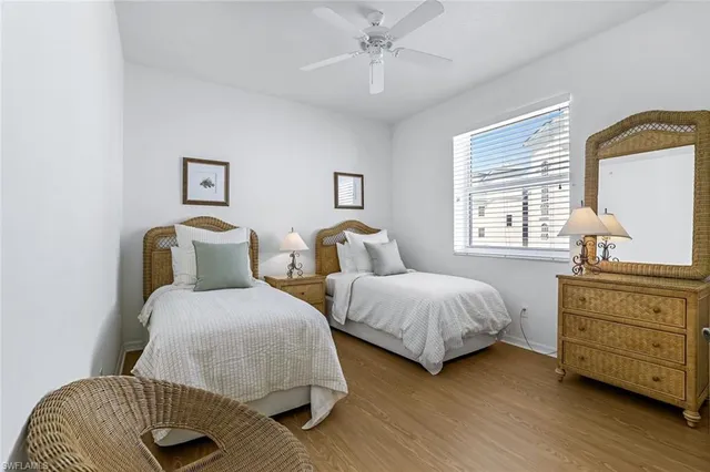 a bedroom with two beds and painting on the wall