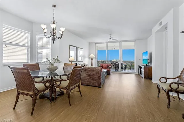 a living room with furniture dining table a window and appliances