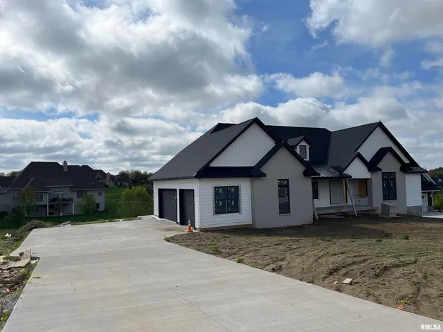 a view of a house with a big yard and large tree