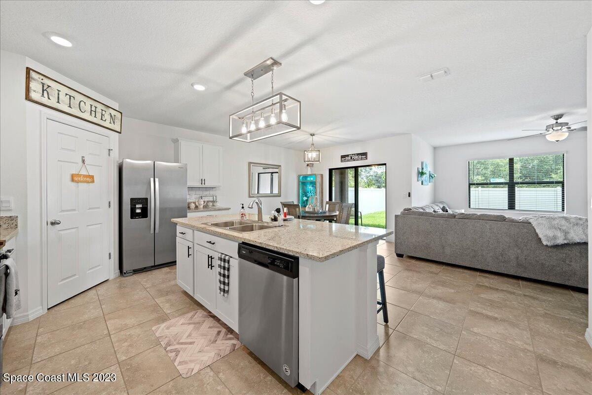 2103 Capital Drive Palm Bay, FL 32909 - Photo 12 of 84 a kitchen with stainless steel appliances granite countertop a sink and a refrigerator