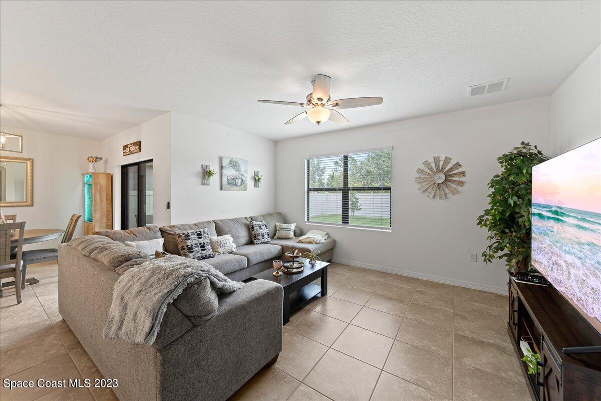 2103 Capital Drive Palm Bay, FL 32909 - Photo 19 of 84 a living room with furniture a flat screen tv and a window