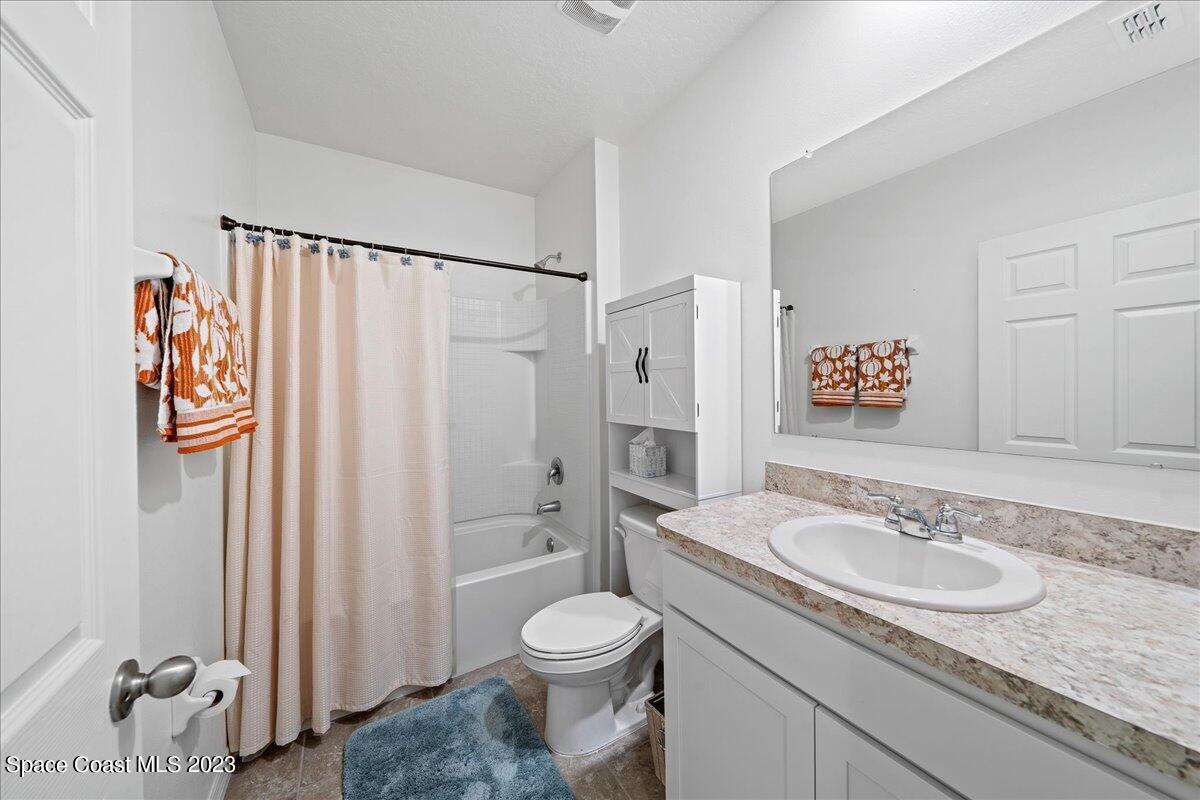 2103 Capital Drive Palm Bay, FL 32909 - Photo 28 of 84 a bathroom with a granite countertop sink and a mirror