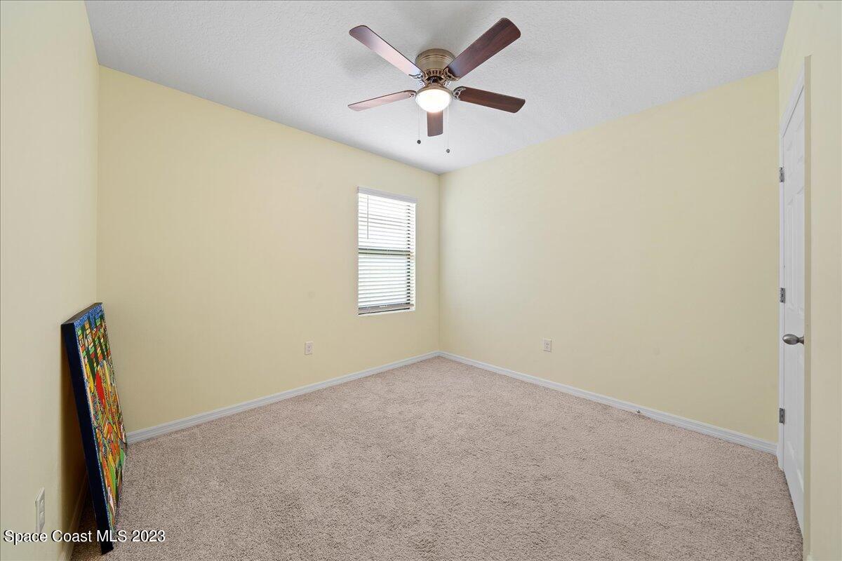 2103 Capital Drive Palm Bay, FL 32909 - Photo 29 of 84 an empty room with windows and fan