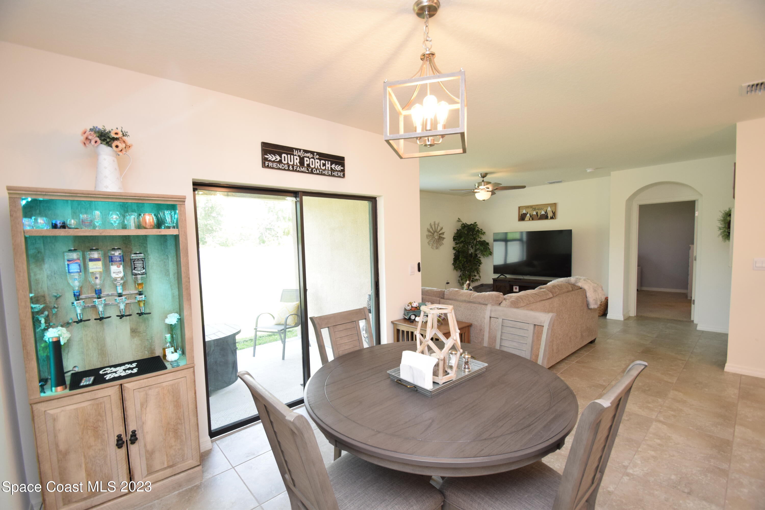 2103 Capital Drive Palm Bay, FL 32909 - Photo 45 of 84 a view of a dining room with furniture a chandelier and wooden floor