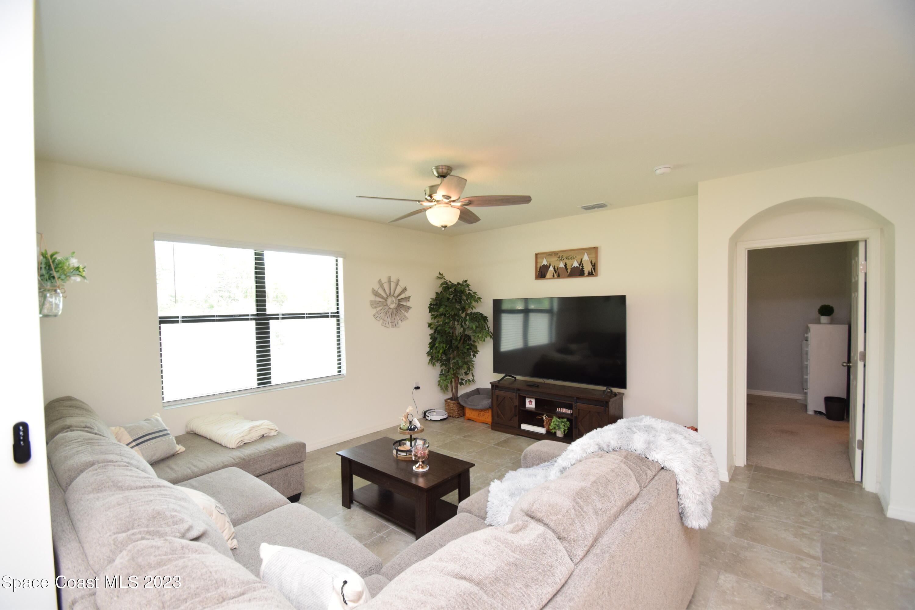 2103 Capital Drive Palm Bay, FL 32909 - Photo 48 of 84 a living room with furniture and a flat screen tv