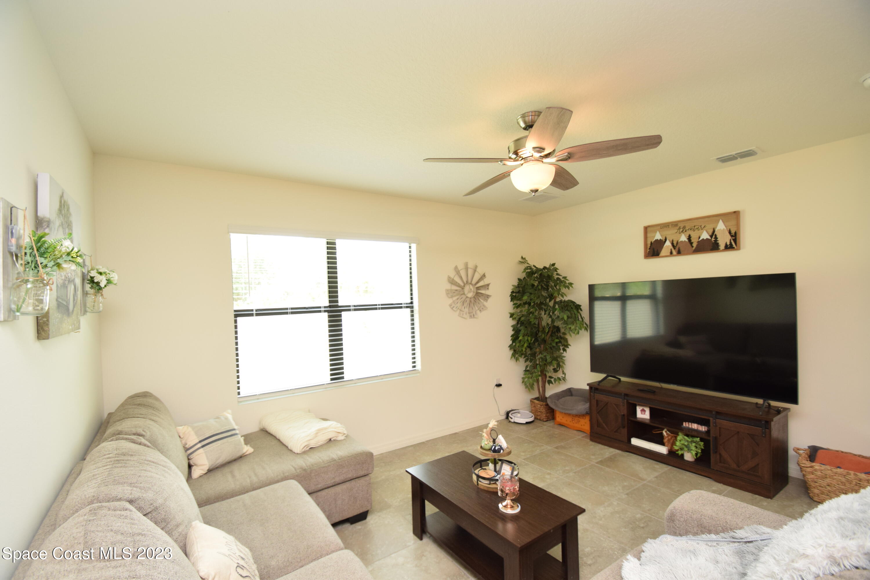 2103 Capital Drive Palm Bay, FL 32909 - Photo 49 of 84 a living room with furniture and a flat screen tv