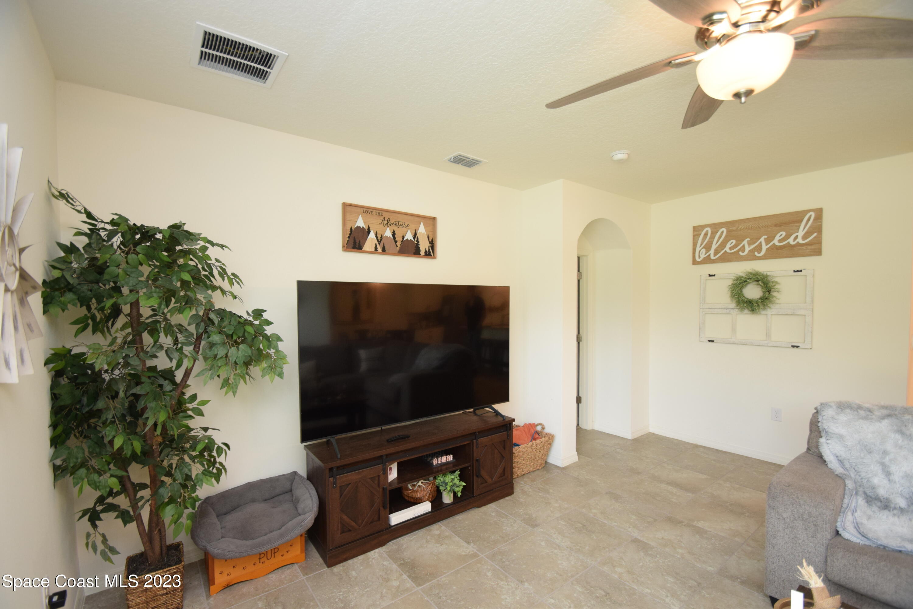 2103 Capital Drive Palm Bay, FL 32909 - Photo 50 of 84 a living room with furniture and a flat screen tv
