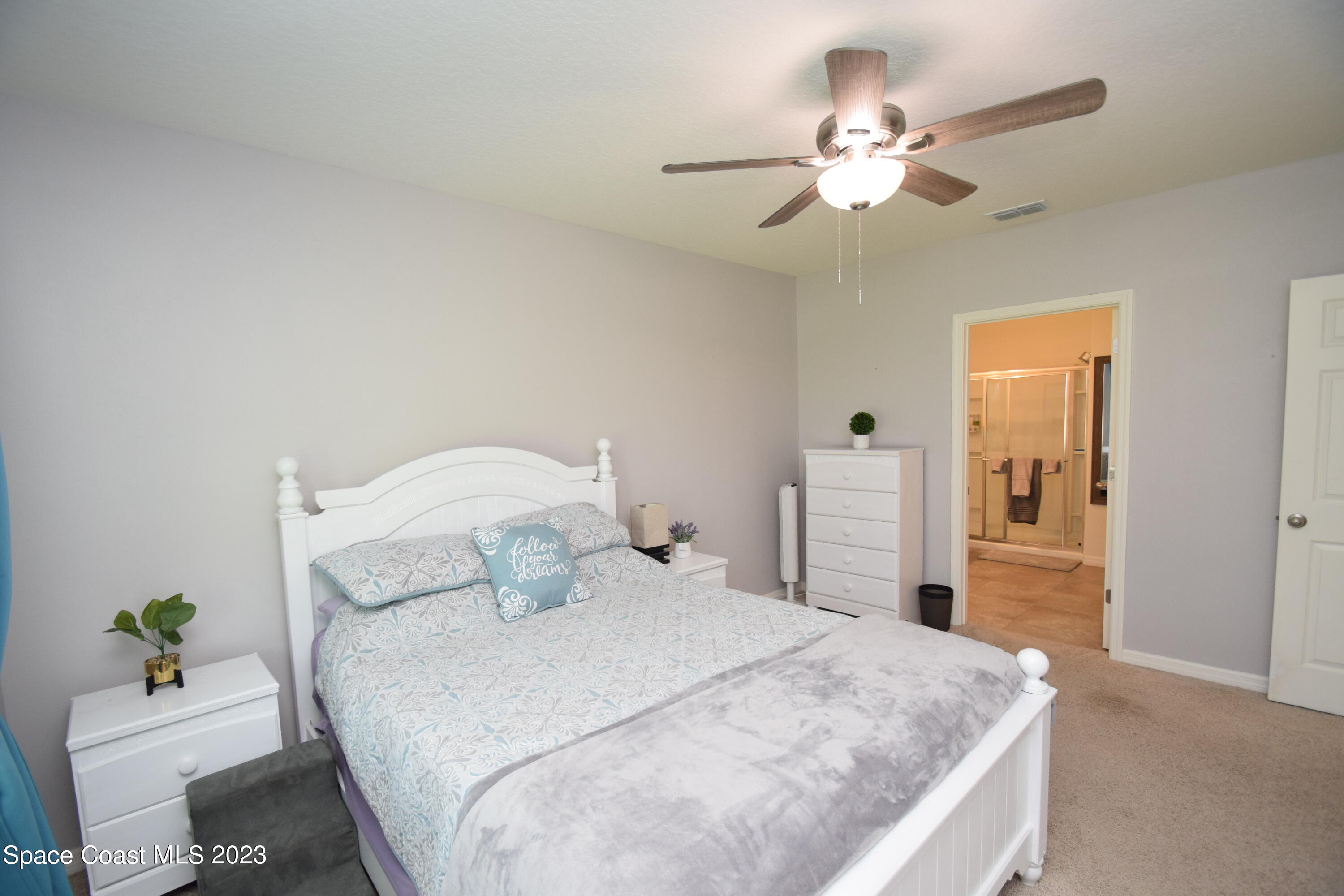 2103 Capital Drive Palm Bay, FL 32909 - Photo 52 of 84 a bedroom with a bed and ceiling fan