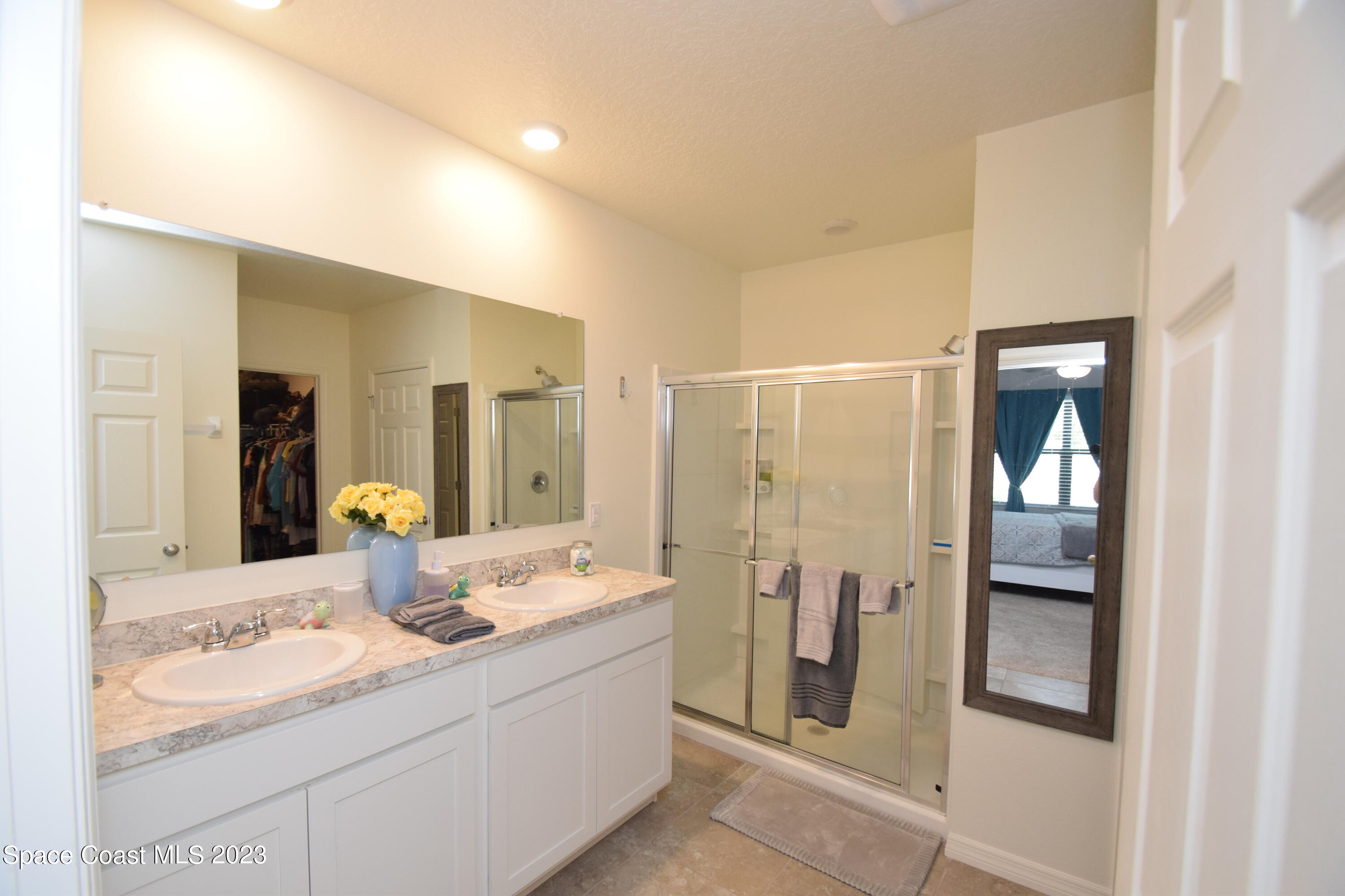 2103 Capital Drive Palm Bay, FL 32909 - Photo 53 of 84 a bathroom with a double vanity sink and mirror