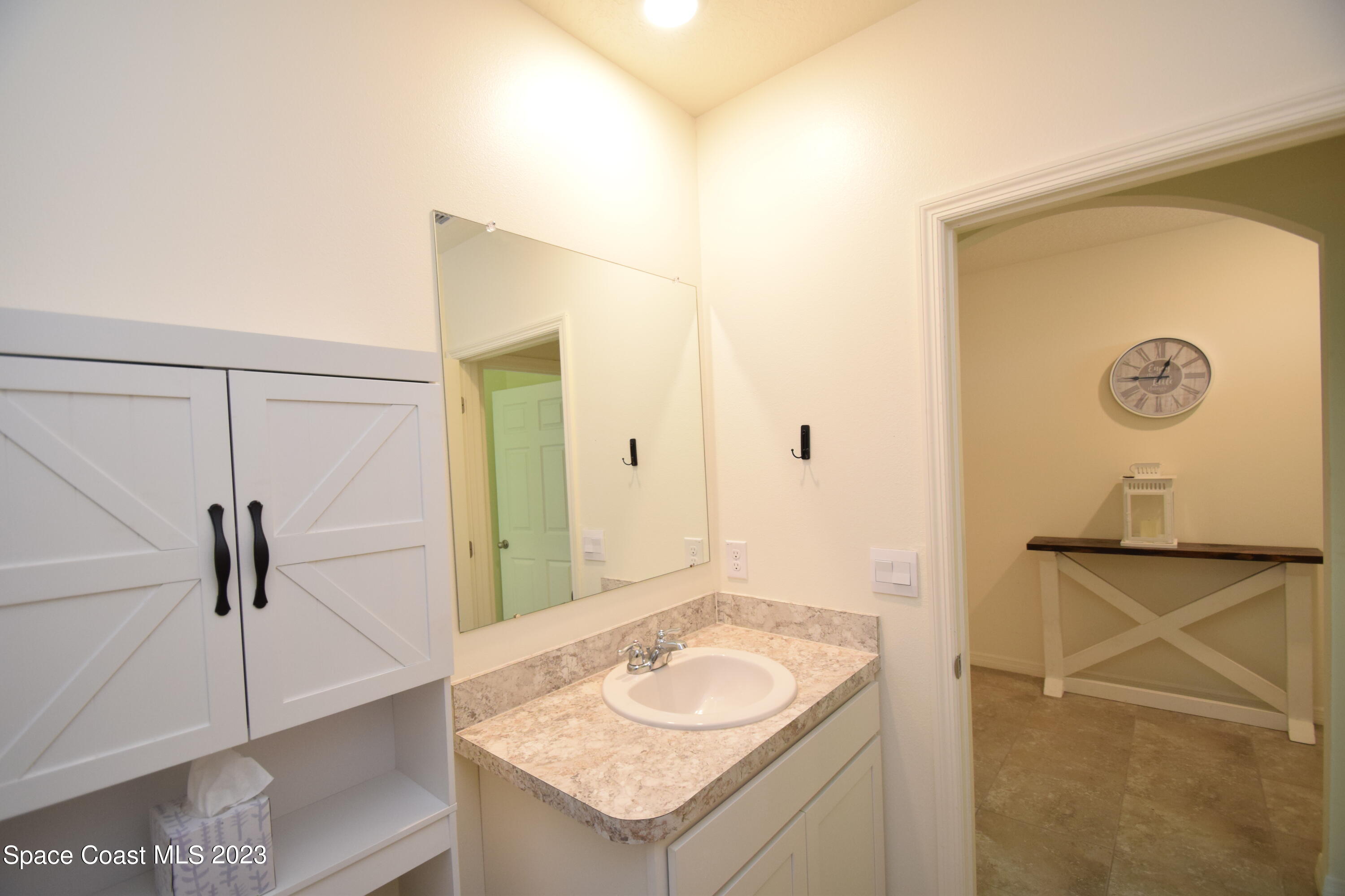 2103 Capital Drive Palm Bay, FL 32909 - Photo 60 of 84 a bathroom with a granite countertop sink and a mirror