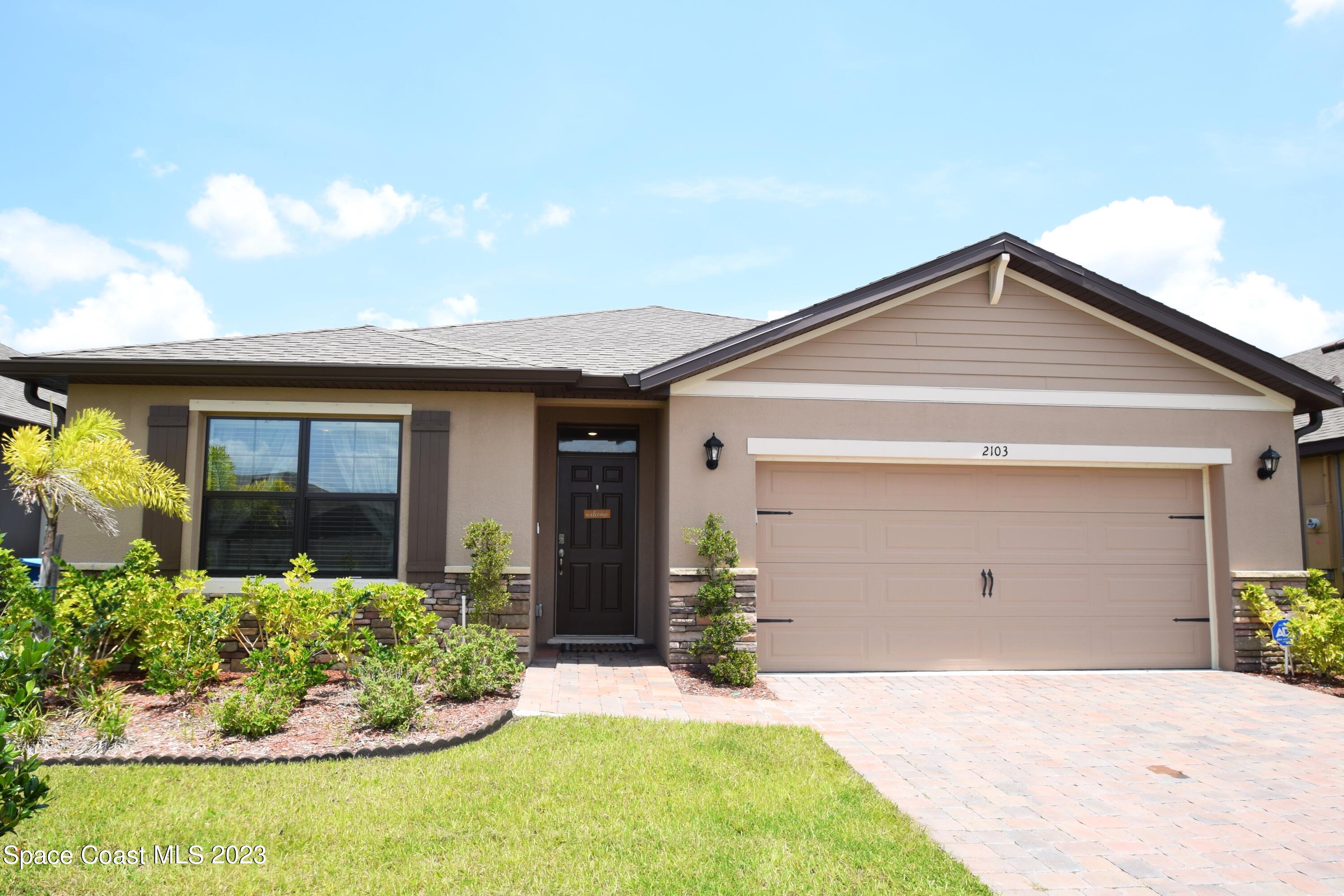 2103 Capital Drive Palm Bay, FL 32909 - Photo 69 of 84 a front view of a house with a yard