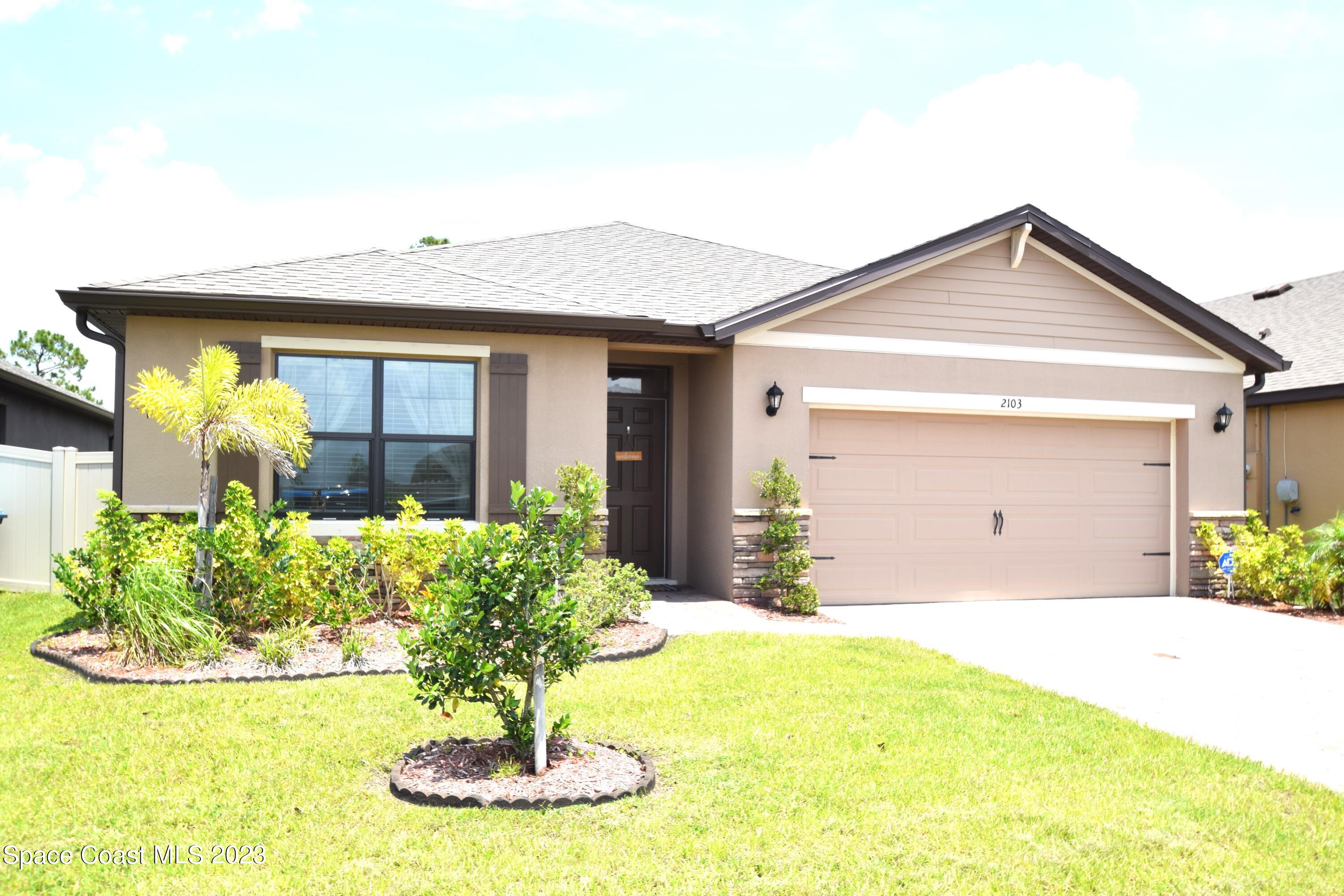 2103 Capital Drive Palm Bay, FL 32909 - Photo 72 of 84 a front view of a house with garden