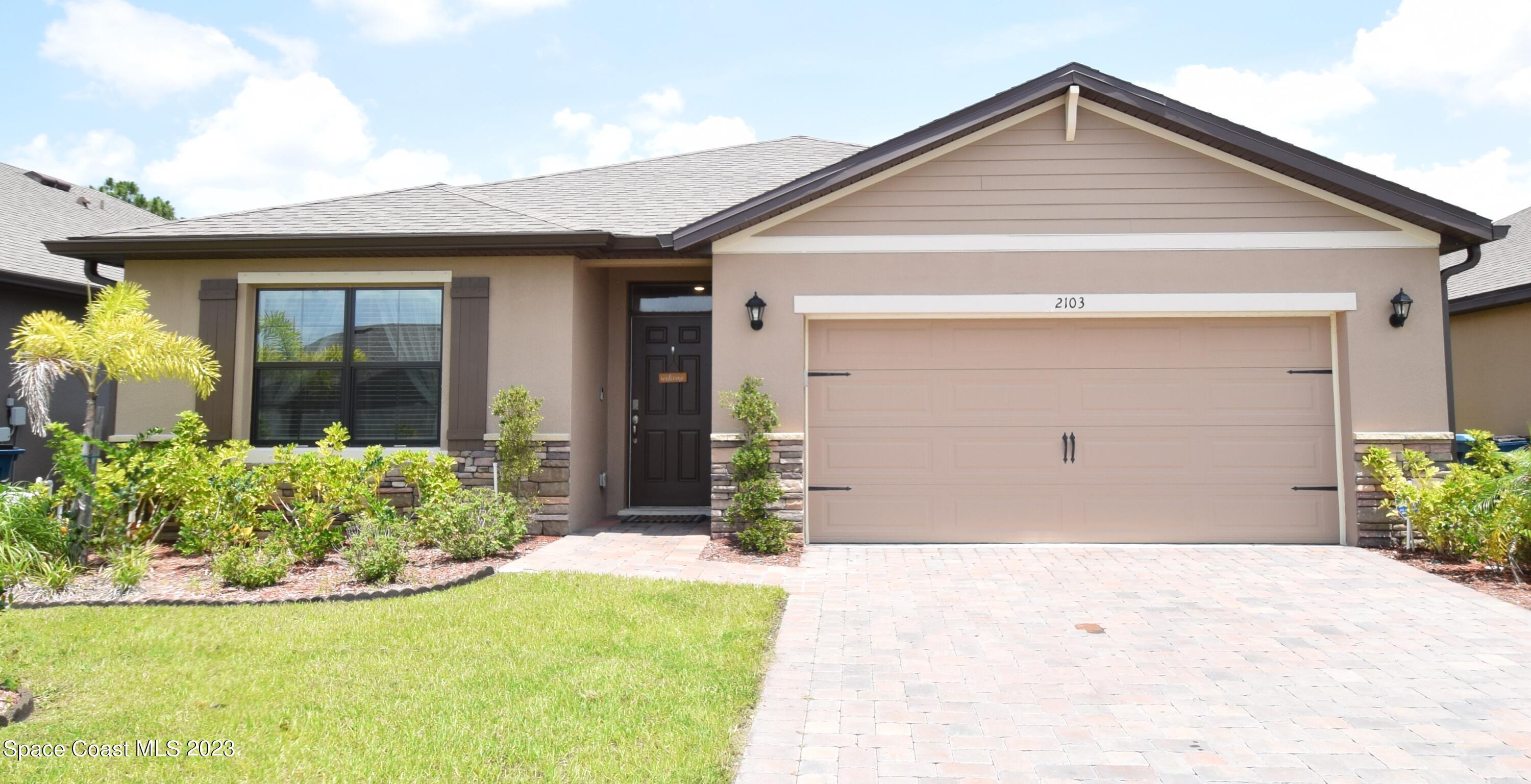 2103 Capital Drive Palm Bay, FL 32909 - Photo 73 of 84 a front view of a house with a yard