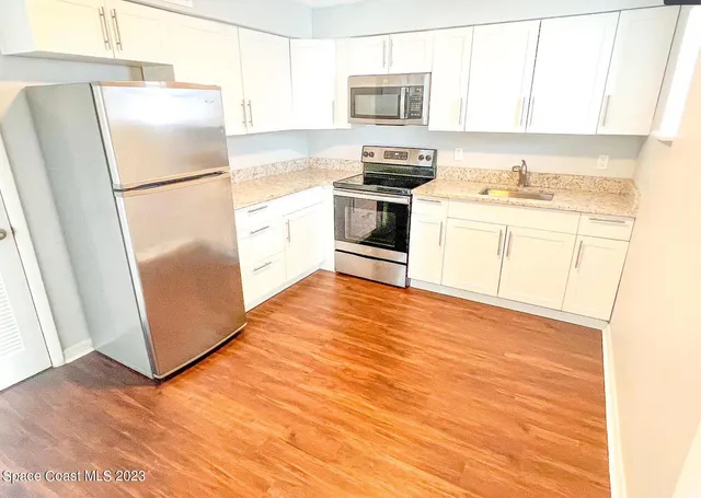 a kitchen with stainless steel appliances a refrigerator stove microwave and sink