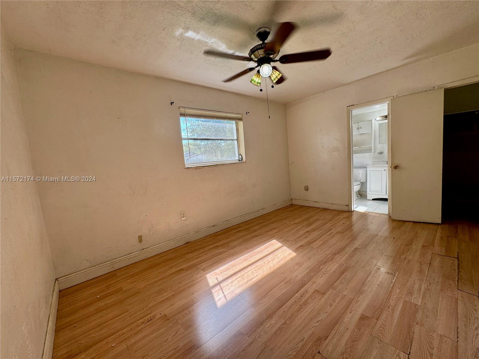4250 Southwest 67th Avenue, Unit 6 Miami, FL 33155 - Photo 11 of 18 a view of a room with wooden floor and ceiling fan