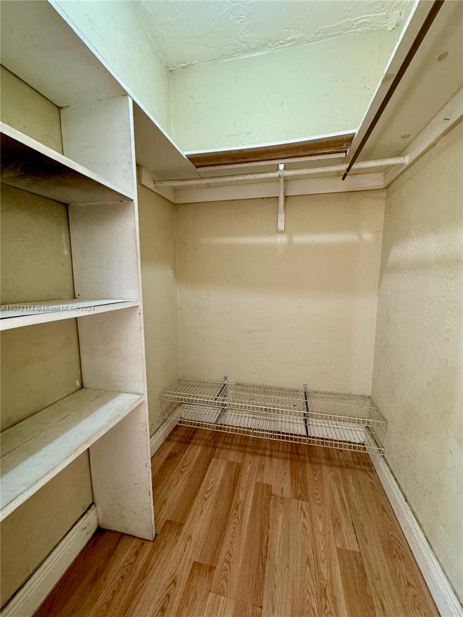 4250 Southwest 67th Avenue, Unit 6 Miami, FL 33155 - Photo 14 of 18 a view of walk in closet with wooden floor