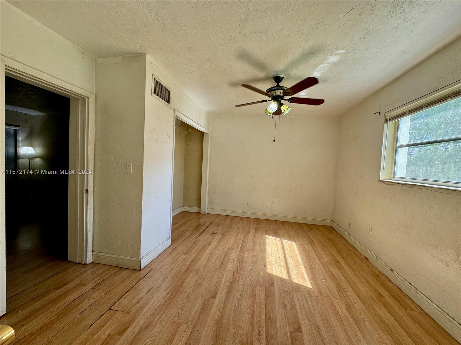 4250 Southwest 67th Avenue, Unit 6 Miami, FL 33155 - Photo 15 of 18 wooden floor in an empty room with a window