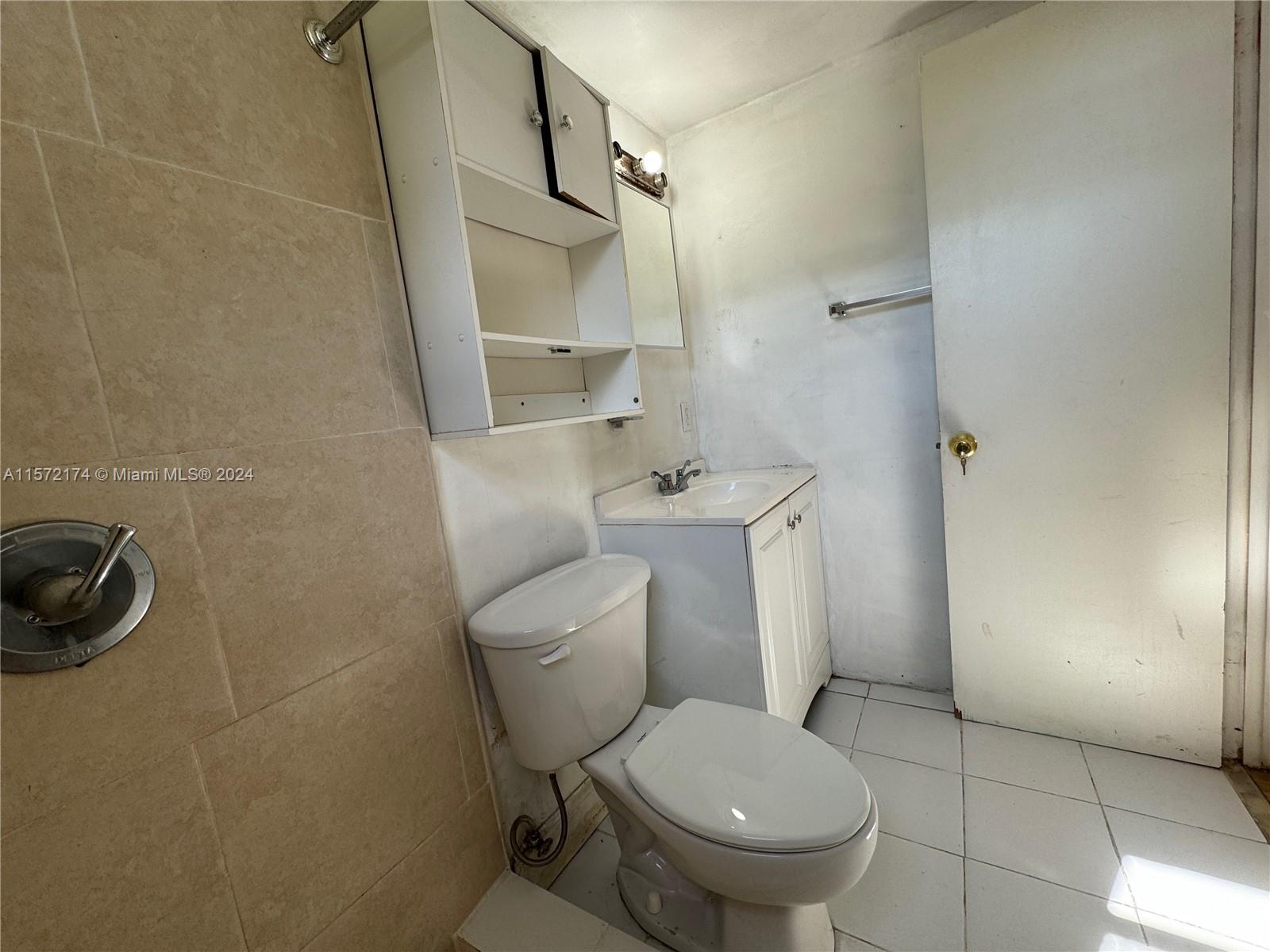 4250 Southwest 67th Avenue, Unit 6 Miami, FL 33155 - Photo 18 of 18 a white toilet sitting next to a bathroom sink