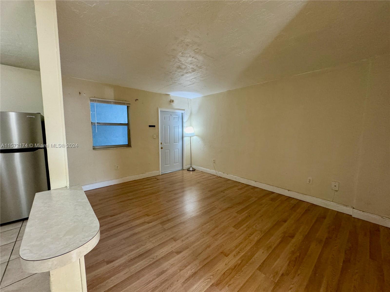 4250 Southwest 67th Avenue, Unit 6 Miami, FL 33155 - Photo 2 of 18 a view of empty room with wooden floor and fan