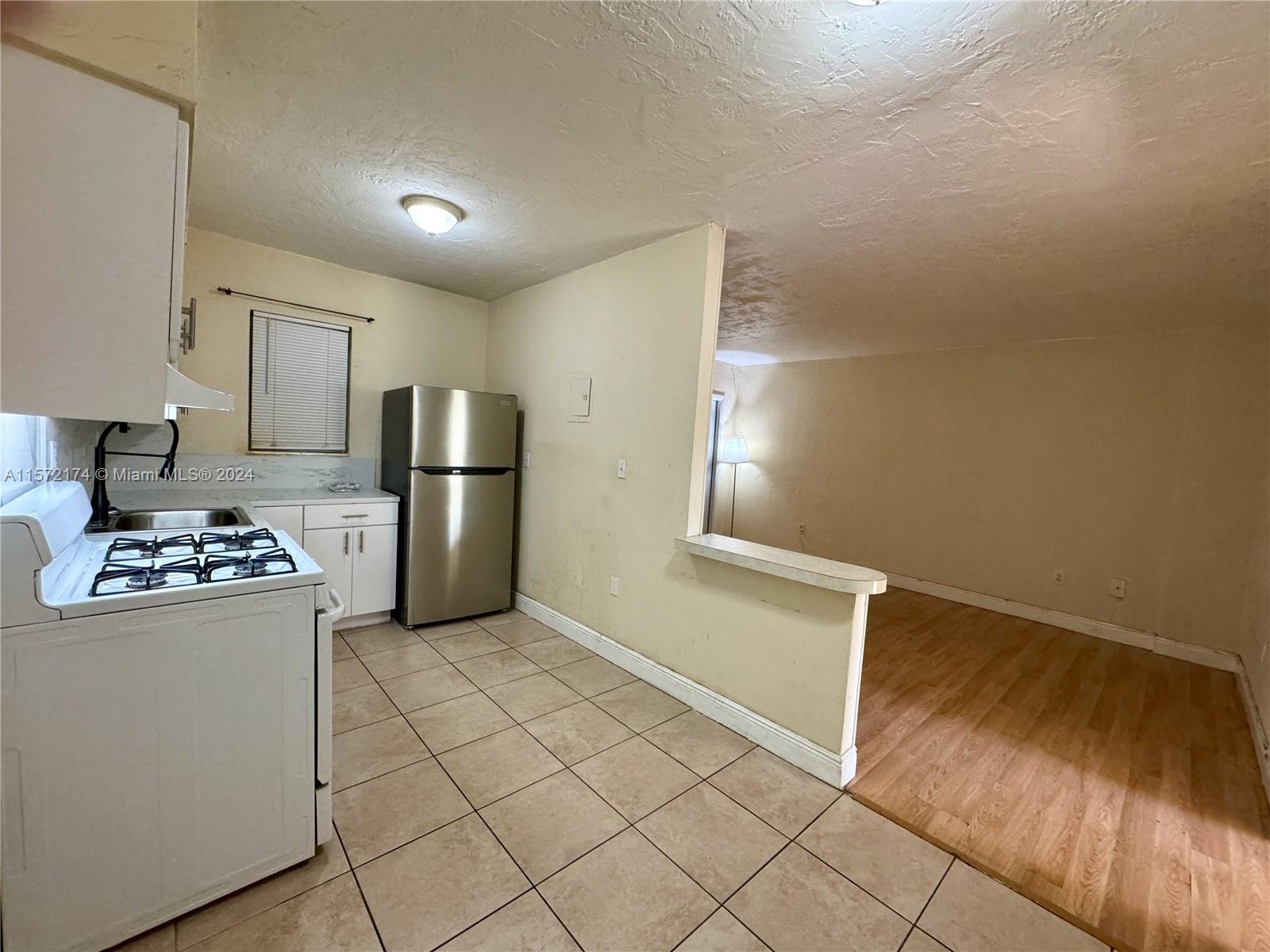 4250 Southwest 67th Avenue, Unit 6 Miami, FL 33155 - Photo 10 of 18 a kitchen with stainless steel appliances a refrigerator and a stove