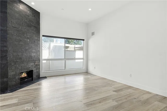 an empty room with wooden floor and closet