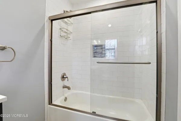 a bathroom with a glass shower door